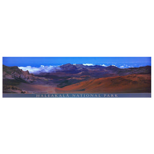 Panoramic poster shows the volcanic summit valley of Haleakalā, with multicolored cinder cones, wispy clouds, and a bright blue sky. 