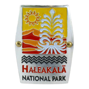Rectangular gold, red, orange and white hiking medallion shows the silversword plant and the rising sun over the cinder cones of the summit of Haleakalā National Park on Maui.