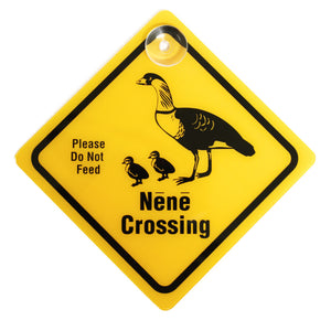 Yellow diamond-shaped placard displays the words NĒNĒ CROSSING and shows a graphic of an adult Hawaiian goose and two goslings.