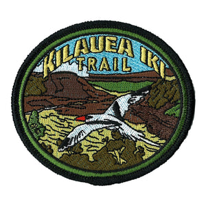 Oval patch has the name "Kīlauea Iki Trail" embroidered in gold over a yellow and brown scene of the crater, with a black and white red-tailed tropicbird soaring in the foreground.